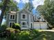Charming two-story home boasts a blue exterior, white trim, two-car garage and is surrounded by lush greenery at 4080 Longford Ne Dr, Marietta, GA 30066