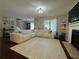 Inviting living room with large sectional sofa, fireplace, and hardwood floors at 4080 Longford Ne Dr, Marietta, GA 30066