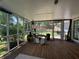 Spacious screened porch with wood floors and views of the landscaped backyard at 4080 Longford Ne Dr, Marietta, GA 30066