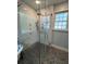 Modern shower enclosure featuring white subway tile, gray mosaic floors, and dual shower heads at 4080 Longford Ne Dr, Marietta, GA 30066