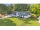 Aerial view of a well-kept one-story house with a spacious lawn and mature trees at 4166 Idlevale Dr, Tucker, GA 30084