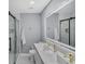 Modern bathroom featuring double vanity, a large, illuminated mirror, and glass enclosed shower at 4166 Idlevale Dr, Tucker, GA 30084
