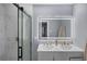 Modern bathroom features double sink vanity, large LED mirror, and glass shower at 4166 Idlevale Dr, Tucker, GA 30084