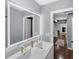 Bathroom with double sink, an illuminated mirror, and doorway access to the hallway and other rooms at 4166 Idlevale Dr, Tucker, GA 30084