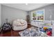 Cozy bedroom with natural light, white storage furniture, and hardwood floors at 4166 Idlevale Dr, Tucker, GA 30084