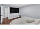 Bedroom with hardwood floors, a large flat-screen TV, and a comfortable bed at 4166 Idlevale Dr, Tucker, GA 30084