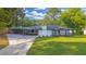 Charming one-story home with a covered carport, front porch, and a well-maintained front lawn at 4166 Idlevale Dr, Tucker, GA 30084