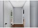 Hallway with hardwood floors, neutral gray walls, and doorways leading to other rooms at 4166 Idlevale Dr, Tucker, GA 30084