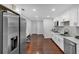 Modern kitchen with stainless steel appliances, white cabinetry, and hardwood floors at 4166 Idlevale Dr, Tucker, GA 30084