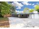 Back view of a home with a carport and concrete driveway surrounded by a fenced yard at 4166 Idlevale Dr, Tucker, GA 30084