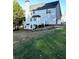 View of a two-story house featuring a white deck and a well-maintained backyard with lush greenery at 6945 Autumn Hills Dr, Cumming, GA 30028
