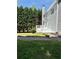 Backyard featuring a patio, a well-maintained lawn, and a wooded backdrop at 6945 Autumn Hills Dr, Cumming, GA 30028