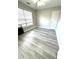 Cozy bedroom with durable flooring, neutral paint, and a bright window at 6945 Autumn Hills Dr, Cumming, GA 30028