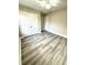 Comfortable bedroom featuring modern flooring, fresh paint, and convenient closet space at 6945 Autumn Hills Dr, Cumming, GA 30028