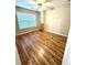 Spacious bedroom featuring hardwood floors, large window with natural light at 6945 Autumn Hills Dr, Cumming, GA 30028