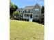 Traditional two-story home boasting stone accents, a front porch, and a well-manicured lawn at 6945 Autumn Hills Dr, Cumming, GA 30028