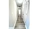 Hallway view featuring hardwood flooring, neutral paint, doors and access to other rooms at 6945 Autumn Hills Dr, Cumming, GA 30028
