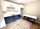 Modern kitchen with white upper cabinets, lower dark blue cabinets and modern countertops at 6945 Autumn Hills Dr, Cumming, GA 30028