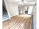 Open-concept living room featuring hardwood floors, neutral paint, with access to other rooms at 6945 Autumn Hills Dr, Cumming, GA 30028