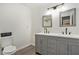 Renovated bathroom with gray double vanity, modern lighting, and stylish fixtures at 2748 Suwanee Se Way, Marietta, GA 30067