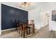 Dining area featuring stylish lighting and a dark accent wall, adjacent to a modern kitchen at 2748 Suwanee Se Way, Marietta, GA 30067