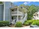 Inviting two-story condo with dual balconies, surrounded by lush greenery and freshly landscaped yard at 2748 Suwanee Se Way, Marietta, GA 30067
