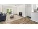 Bright, open living room featuring a cozy fireplace, modern flooring, and lots of natural light at 2748 Suwanee Se Way, Marietta, GA 30067