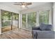 Bright sunroom with hardwood floors, multiple windows, and sliding glass door to the deck at 2748 Suwanee Se Way, Marietta, GA 30067