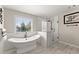 Luxurious bathroom with freestanding tub, glass-enclosed shower, and modern fixtures at 3524 Old Towne Ln, Cumming, GA 30040