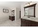 Dual vanities feature granite counters, dark wood cabinets, and modern lighting at 3524 Old Towne Ln, Cumming, GA 30040