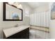 Cozy bathroom with modern vanity, stylish mirror, and shower with curtain at 3524 Old Towne Ln, Cumming, GA 30040