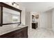 Bright bathroom showcases dual vanities with granite counters and dark wood cabinets at 3524 Old Towne Ln, Cumming, GA 30040