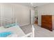 Cozy bedroom with carpeted floors and a white door frame with a view of the hallway at 3524 Old Towne Ln, Cumming, GA 30040
