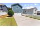Exterior view of the two-car garage with driveway and fenced yard at 3524 Old Towne Ln, Cumming, GA 30040