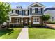 Charming two-story home featuring brick accents, manicured lawn, and inviting front porch at 3524 Old Towne Ln, Cumming, GA 30040