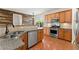 Stylish kitchen featuring granite countertops, stainless steel appliances, and wooden cabinets at 3524 Old Towne Ln, Cumming, GA 30040