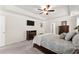 Well-lit main bedroom with a stylish bed and tray ceiling, perfect for relaxation at 3524 Old Towne Ln, Cumming, GA 30040