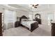 Spacious main bedroom with tray ceiling, plush carpet, and elegant furnishings at 3524 Old Towne Ln, Cumming, GA 30040