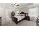 Comfortable main bedroom with a tray ceiling and dark wood furniture at 3524 Old Towne Ln, Cumming, GA 30040