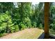 Enjoy the view from the porch into the wooded backyard at 63 Brookstone E Park, Acworth, GA 30101