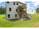 Two-story home exterior featuring a covered porch and sprawling green backyard at 63 Brookstone E Park, Acworth, GA 30101