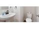 Bathroom featuring a pedestal sink with a dark faucet and a toilet with a chrome handle at 63 Brookstone E Park, Acworth, GA 30101
