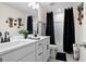 Contemporary bathroom featuring dual sinks, sleek black hardware, and stylish black shower curtains at 63 Brookstone E Park, Acworth, GA 30101