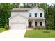 Charming two-story home with a well-manicured lawn and a welcoming front porch and attached two car garage at 63 Brookstone E Park, Acworth, GA 30101