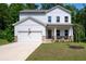 Charming two-story home featuring stone accents, a covered porch, and an attached two-car garage at 63 Brookstone E Park, Acworth, GA 30101