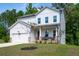 Charming two-story home featuring stone accents, a covered porch, and an attached two-car garage at 63 Brookstone E Park, Acworth, GA 30101