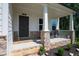 Inviting front porch with stone details, a comfortable seating area, and charming outdoor decor at 63 Brookstone E Park, Acworth, GA 30101