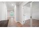 Bright hallway with hardwood floors and neutral paint, featuring glass-paned interior doors at 63 Brookstone E Park, Acworth, GA 30101