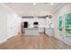 Bright, open kitchen featuring white cabinets, stainless appliances, and an island with quartz countertops at 63 Brookstone E Park, Acworth, GA 30101
