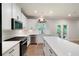 Kitchen featuring white cabinets, stainless appliances, and an island with quartz countertops and gas stove at 63 Brookstone E Park, Acworth, GA 30101